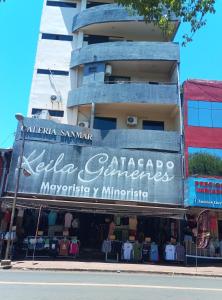 a building with a sign for a clothing store at Ada 507 avenida pioneros del este in Ciudad del Este +3 photos