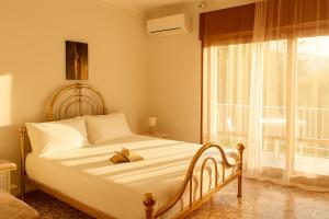 a bed in a room with a large window at Exclusive Large 3 bed room Apartment with Pool Central Sorrento in Sorrento +24 photos