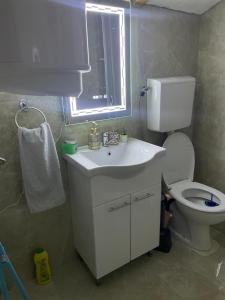 a bathroom with a white sink and a toilet at Yugoslavija Lux 3 in Aleksandrovac +22 photos