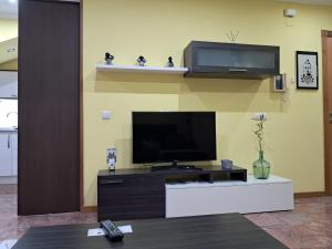 a living room with a flat screen tv on a wall at Ultreia in Arcade