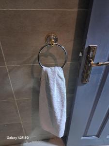 a towel hanging on a towel rack in a bathroom at Hayat Pyramids House DBL 59S in ‘Ezbet `Abd el-Ḥamîd