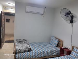 a bedroom with a bed and a fan at Hayat Pyramids House DBL 59S in ‘Ezbet `Abd el-Ḥamîd +4 photos