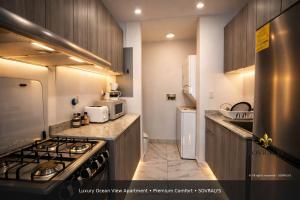 a kitchen with a stove and a stove top oven at 80M Luxury Ocean View Apartment PH The Sands, Next to Hilton in Panama City