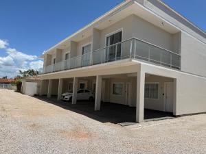 a white car parked in front of a building at Sobrado com garagem e churrasqueira in Tijucas