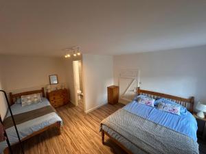 a bedroom with two beds and a door to a bathroom at Gites Le Chezeau in Saint-Amand-Magnazeix +89 photos