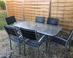 a metal table and chairs sitting around a table at Gîte Ruoms in Ruoms +9 photos