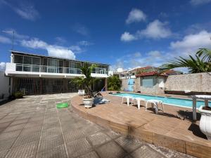 a resort with a swimming pool and a building at Casa Beira Mar lha de Itamaracá in Itamaracá