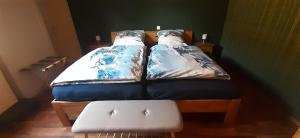 a bed with two pillows on it in a room at Haus am Bach in Miehlen +19 photos