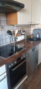 a kitchen with a stove top oven in a kitchen at Haus am Bach in Miehlen