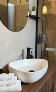 a bathroom with a white sink and a mirror at Attico con vista unica in Scalea