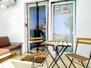 a room with a table and chairs in front of a window at Studio Murdeira Side Beach, Eco Protected Bay, Pool 161B in Beirona