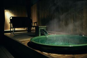 a green bath tub with steam coming out of it at BLANC FUJI in Fujiyoshida