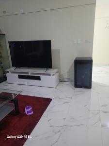 a living room with a flat screen tv on a wall at bienvenido a casa in San Pedro de Macorís