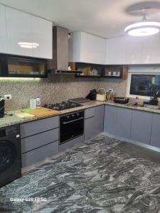 a kitchen with white cabinets and a black appliance at bienvenido a casa in San Pedro de Macorís