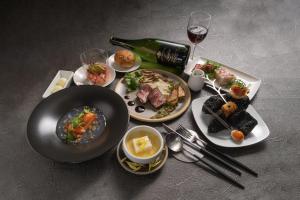 a table with plates of food and a bottle of wine at BLANC FUJI in Fujiyoshida