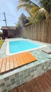 a swimming pool in front of a wooden fence at Flats Bougainville in Marau
