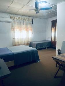 a room with two beds and a ceiling at La Casa de la Abuela in Paso de los Libres
