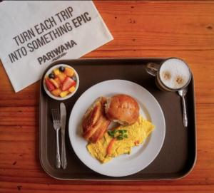 a tray with a plate of breakfast food on a table at Pariwana Hostel Lima in Lima +103 photos