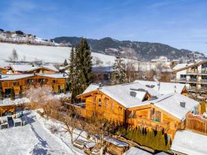 a log cabin in the snow with snow covered roofs at Adventure Lodge Kaprun in Kaprun