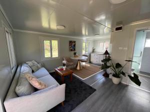 a living room with a couch and a table at Cosy Mountain Cabin in Lawson +5 photos