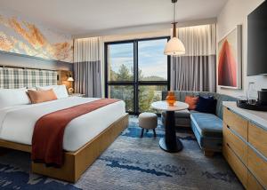a hotel room with a bed and a couch at Limelight Mammoth in Mammoth Lakes