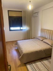 a bedroom with a large bed and a window at Miloche home in Oulad Akkou