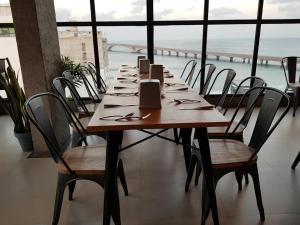 a long wooden table with chairs and a view of the ocean at Park View Stay in Male City