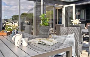 an open book on a table on a patio at Pet Friendly Home In Faaborg With Sauna in Faaborg
