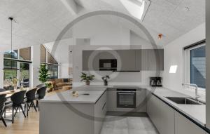 a kitchen with white counters and a dining room at Pet Friendly Home In Faaborg With Sauna in Faaborg
