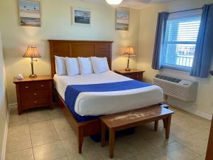 a bedroom with a large bed and two night stands at Beachgate Condo Suites and Hotel 533 condo in Port Aransas