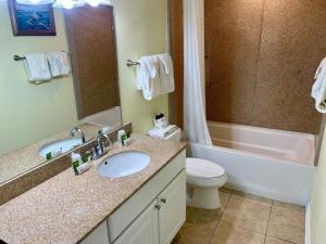 a bathroom with a sink and a tub and a toilet at Beachgate Condo Suites and Hotel 533 condo in Port Aransas