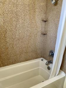 a bathroom with a bath tub with a sink at Beachgate Condo Suites and Hotel 436 condo in Port Aransas