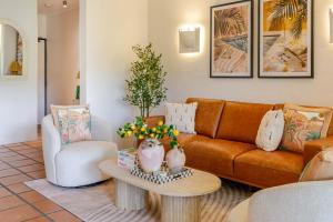 a living room with a couch and a table at Let's Get Tropical, Located In The Heart Of Town, 2 King Beds, 2 Pools, 2 Bathrooms in Port Douglas