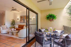 a living room with a table and chairs at Let's Get Tropical, Located In The Heart Of Town, 2 King Beds, 2 Pools, 2 Bathrooms in Port Douglas +16 photos