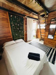 a bedroom with a white bed with a black towel on it at La playita ocean view in Playa Blanca