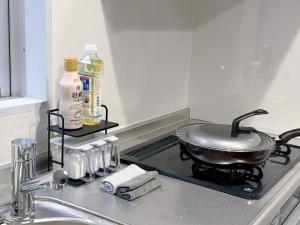 a frying pan on a stove top in a kitchen at HennaWatei in Osaka +56 photos