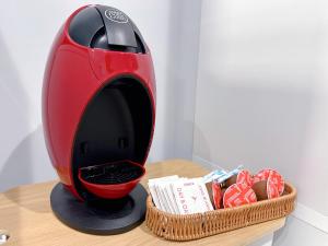 a toaster on a table next to a basket of cookies at HennaWatei in Osaka