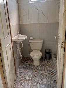 a bathroom with a toilet and a sink at La Luna cabin in Amagá