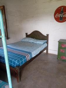 a bedroom with a bunk bed with a blue comforter at La Luna cabin in Amagá