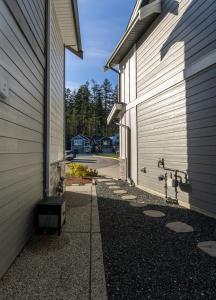 a side view of a building with a driveway at Cozy Corner on Trumpeter in Colwood