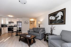 a living room with a couch and a table at Cozy Corner on Trumpeter in Colwood