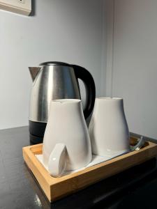 two white cups on a wooden tray with a coffee pot at Siqui Pods in Siquijor +25 photos