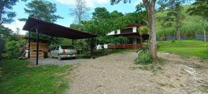 a car parked in front of a house at Casa en el campo - villeta in Villeta