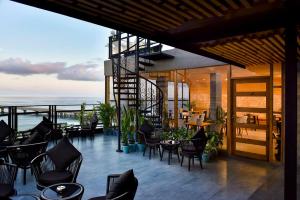 a patio with chairs and tables and a view of the ocean at Park View Stay in Male City
