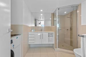 a bathroom with a shower and a sink at Proximity Waterfront Apartments in Redcliffe