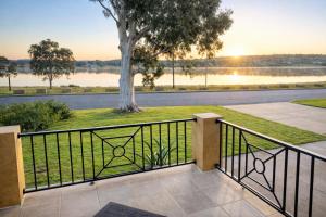 a balcony with a view of a tree at Luxury Lake Front Living in Lake Albert