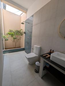 a bathroom with a shower and a toilet and a sink at Villa Sethoskai -100m to Beach in Ambalangoda +35 photos