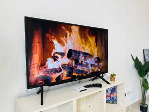a flat screen tv sitting on top of a white cabinet at Pinnacle Pj by DeUrban in Petaling Jaya
