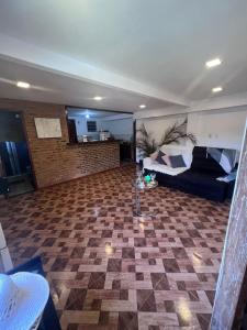 a living room with a bed and a couch at Granja Bagdá in Araras Petropolis