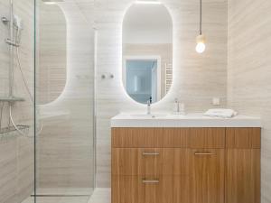 a bathroom with a sink and a mirror at Comfortable apartment, right on the beach in Niechorze +21 photos